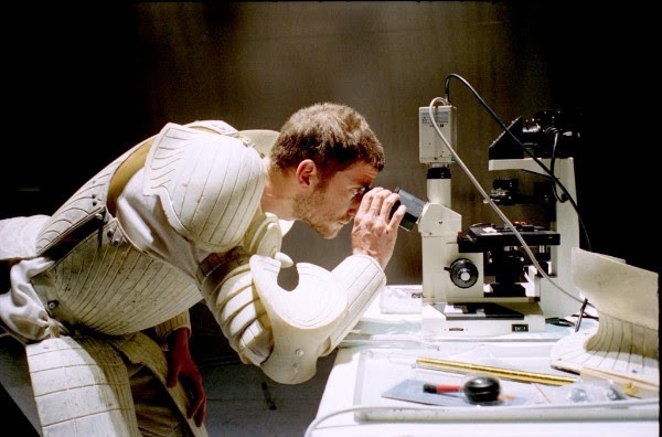 Picture of a knight using a microscope
