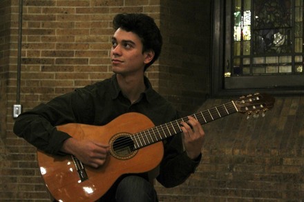 Sam Klein-Markman holding a guitar.