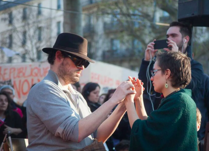 Picture of two people holding hands during a protest