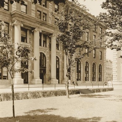 An old sepia-colored photo of Dodge Hall. The trees out front are young and small.