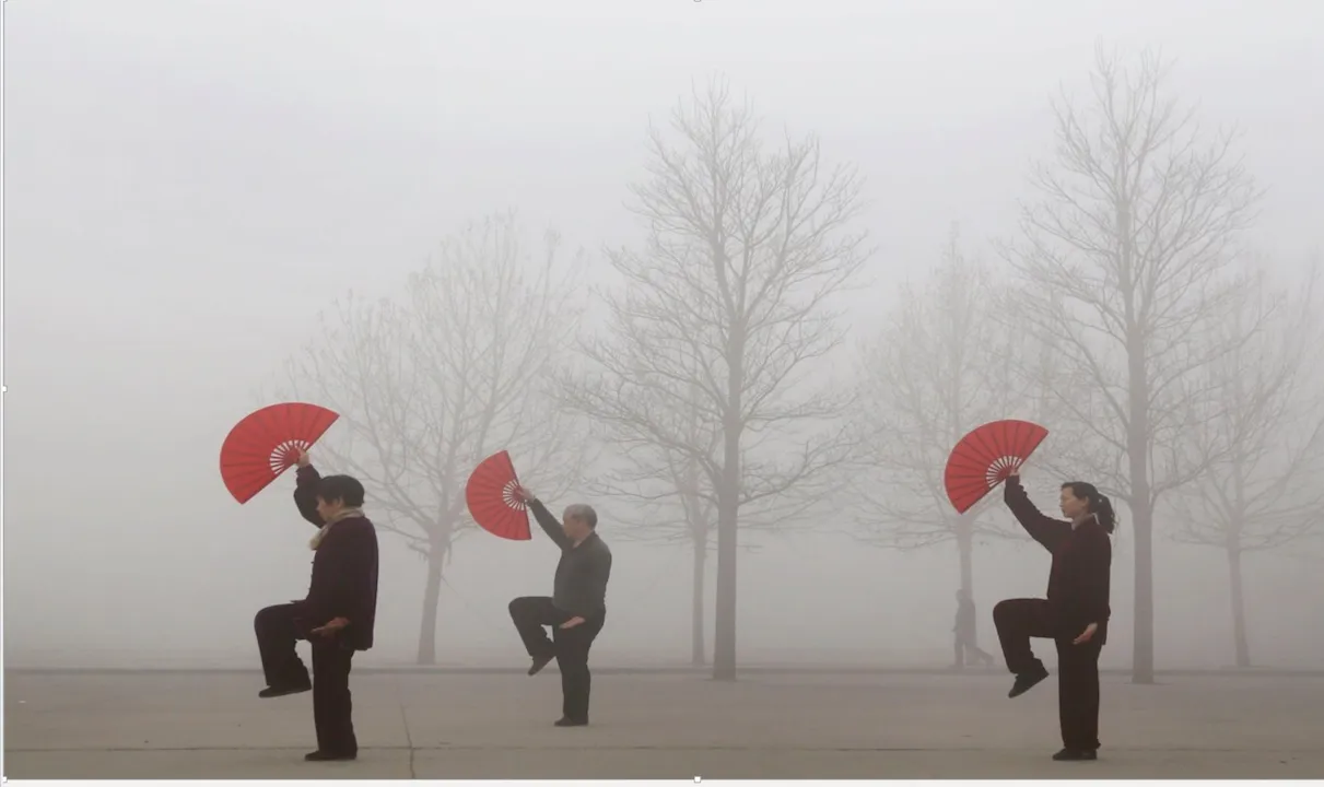 Picture of three people posing holding hand fans