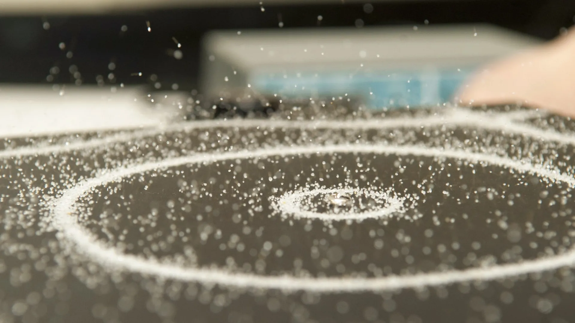 Picture of sand rings forming to vibrations