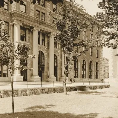 An old sepia-colored photo of Dodge Hall. The trees out front are young and small.