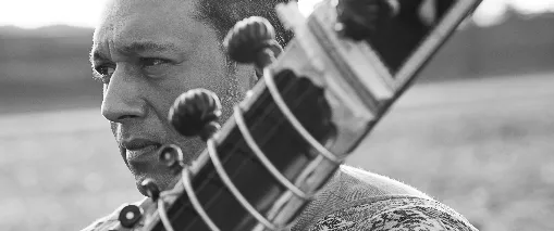 Hidayat Khan, with a sitar, in black and white