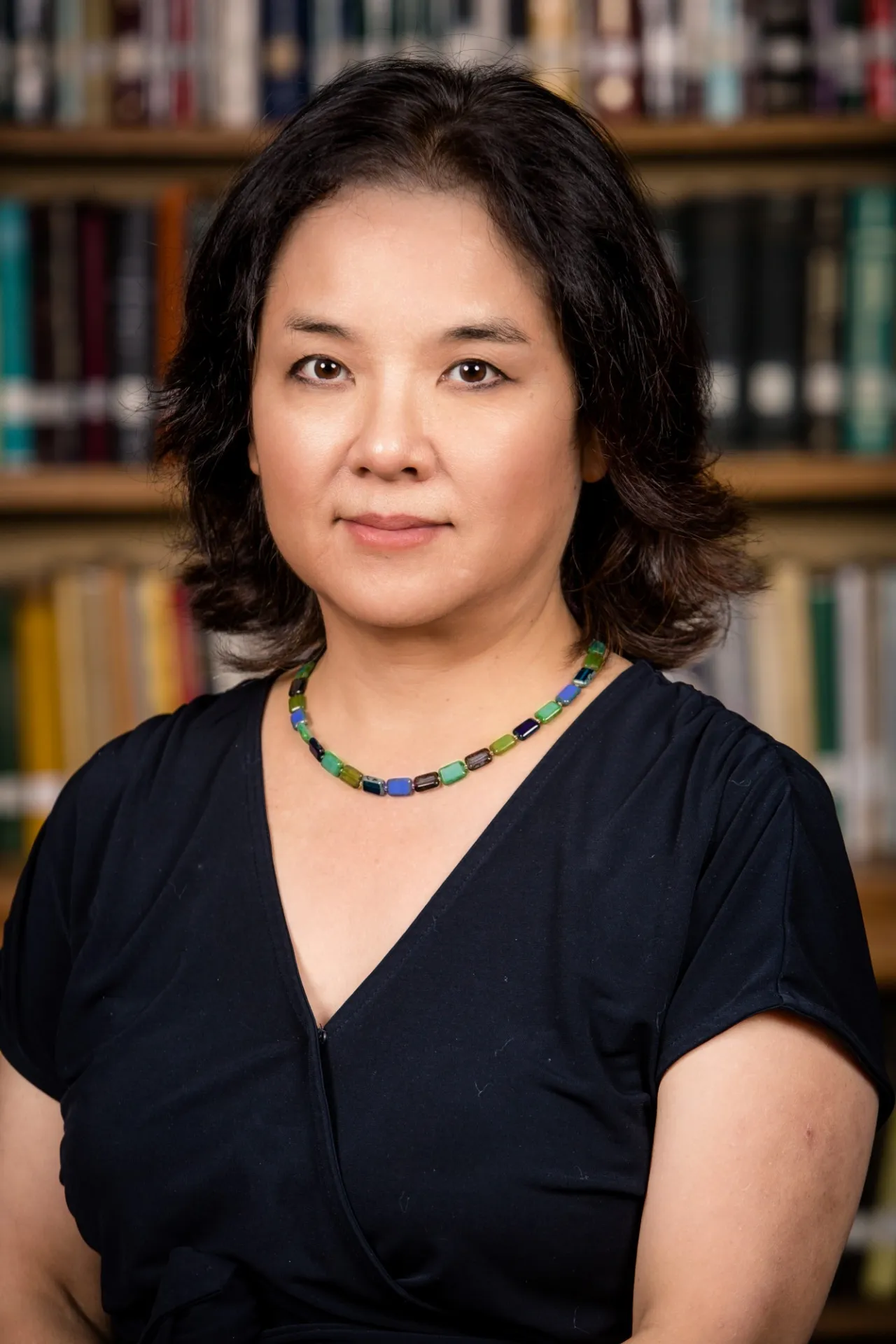 Credit for photograph:
Andrea Kane, Institute for Advanced Study

Ellie Hisama in a black top in front of a wall of books.