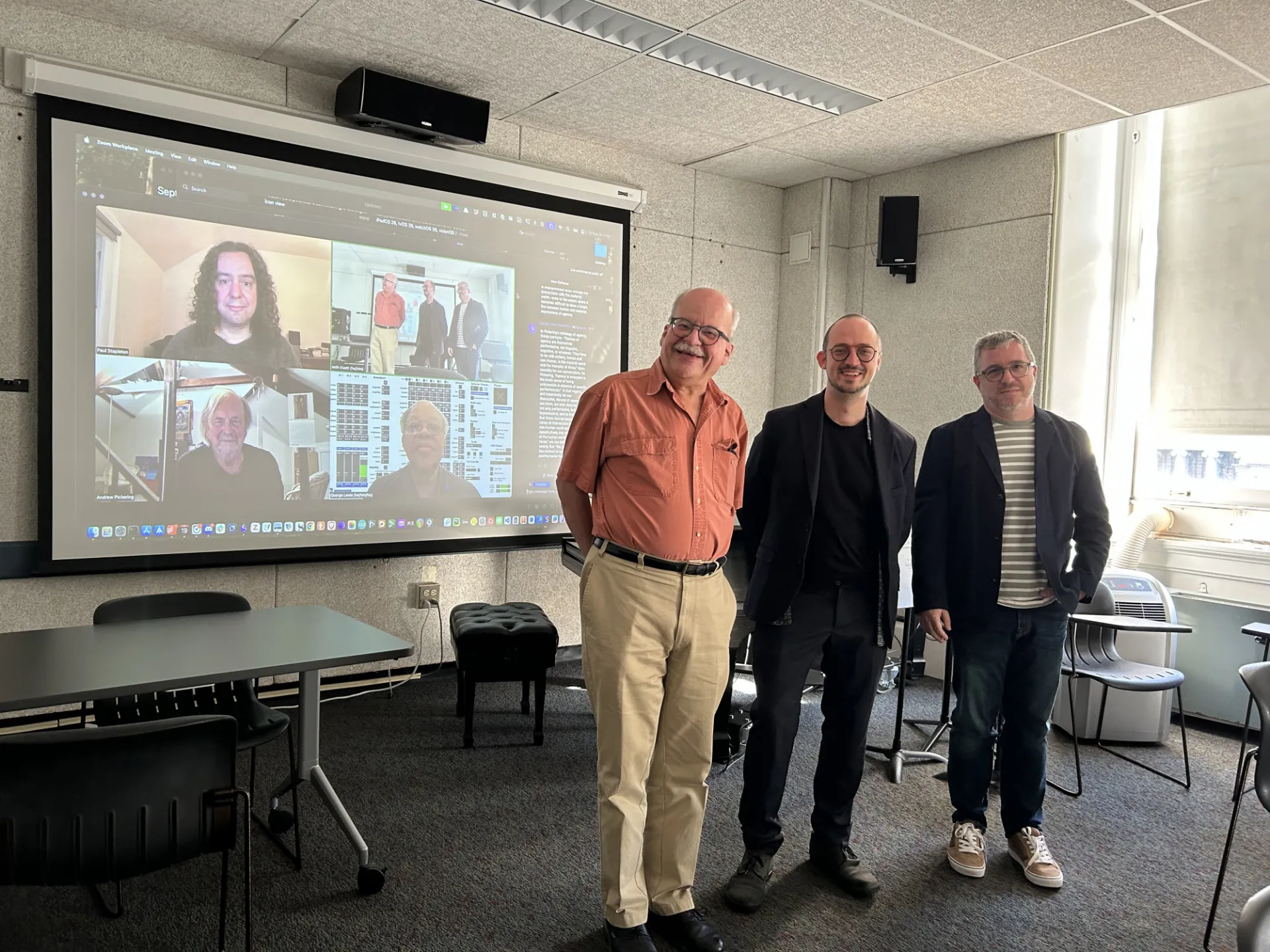 Nicola with Joe Dubiel and Seth Cluett. The other committee members are on the computer screen in the background.