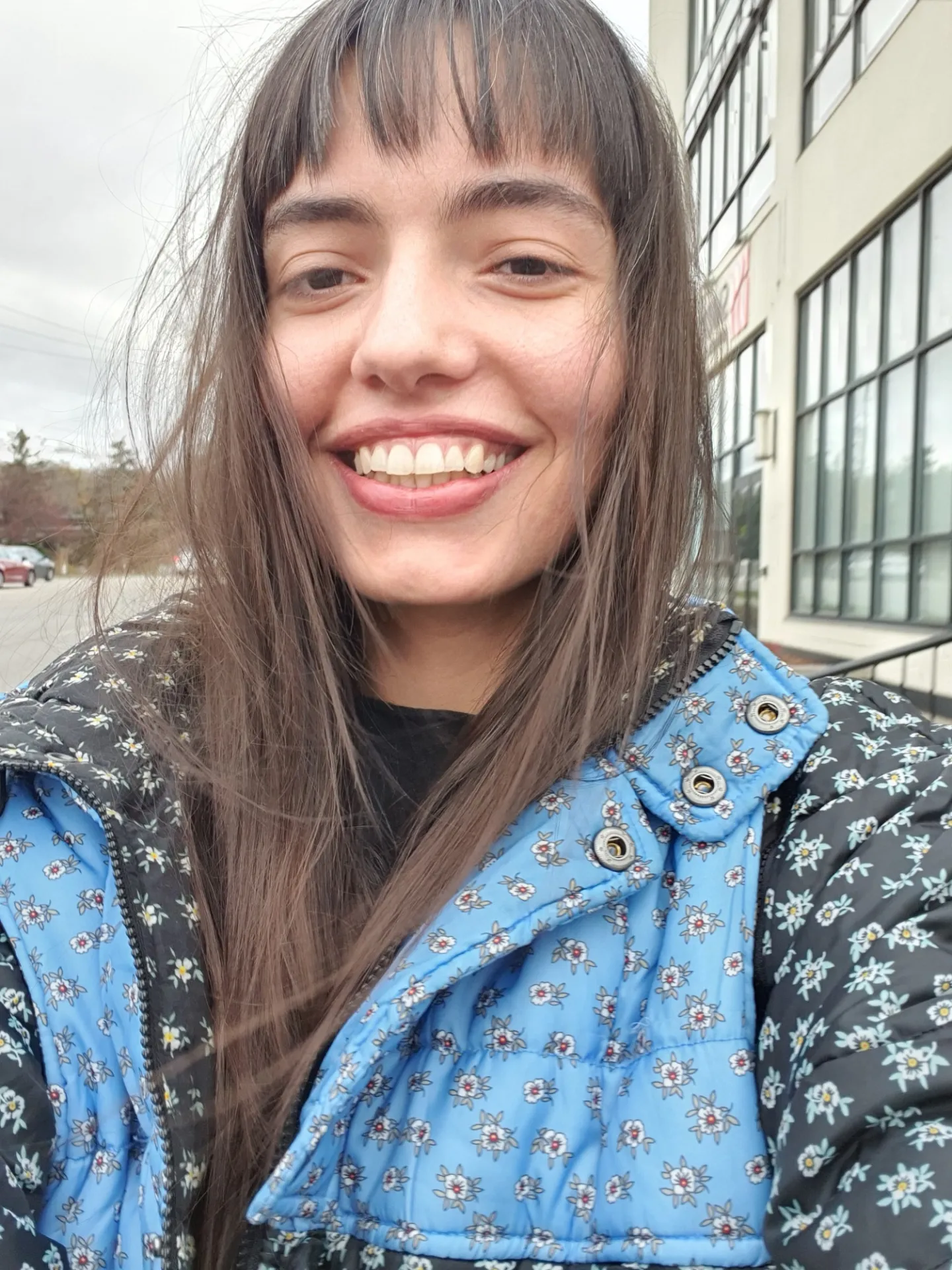 Rojin Kashani outside in a black and blue patterned coat.