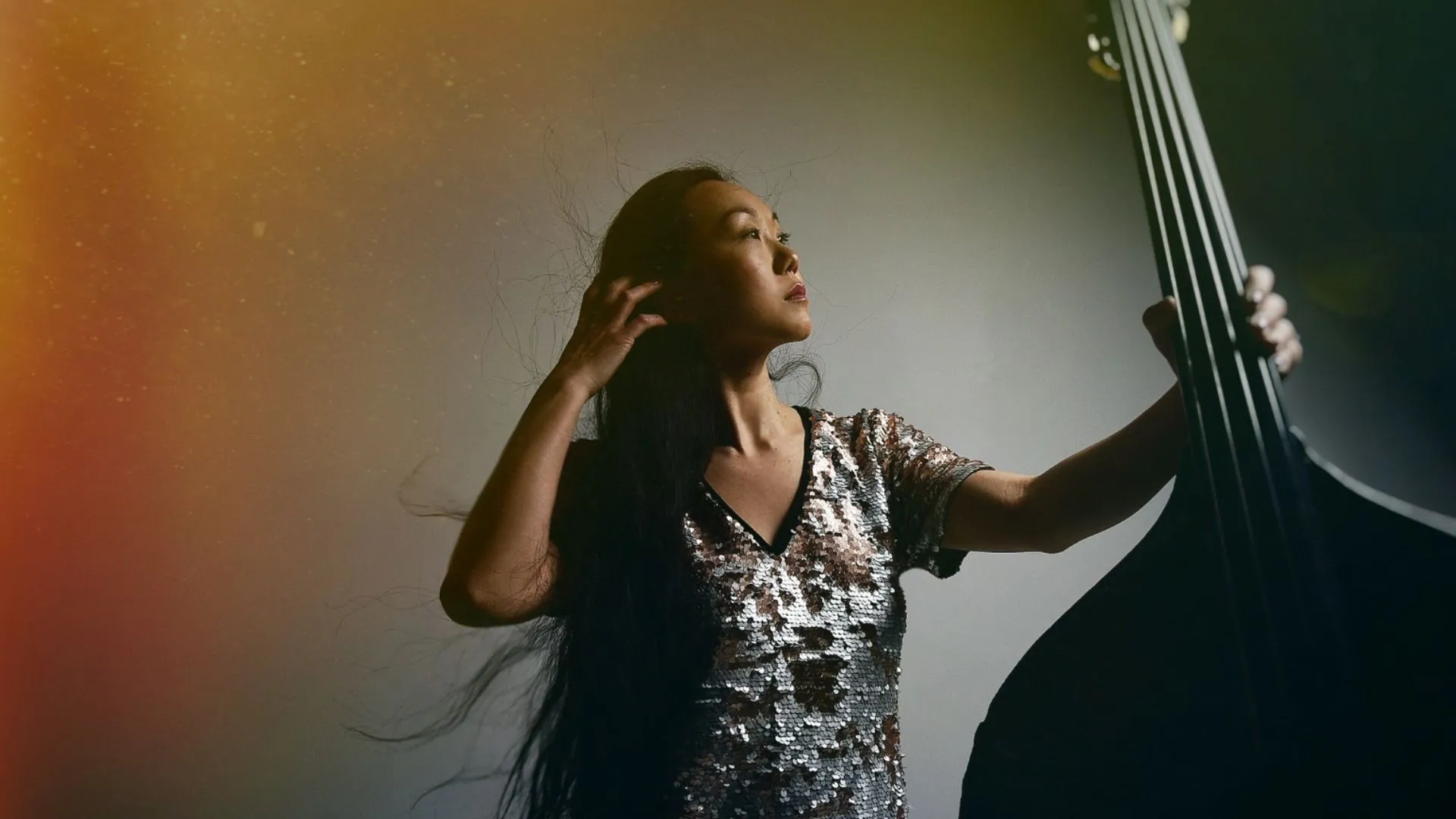 Linda Oh in a sparkly top with her bass.